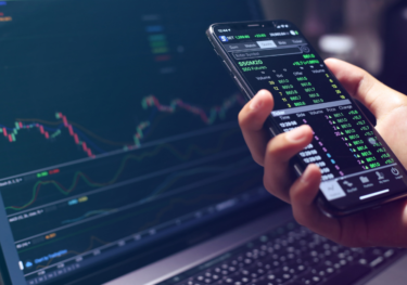 Image of investment screen and phone